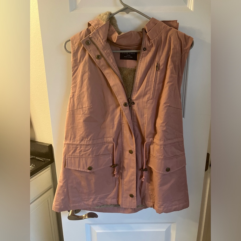 Hooded, fur-lined vest.